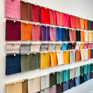 Wall of fabric swatches and brim templates
